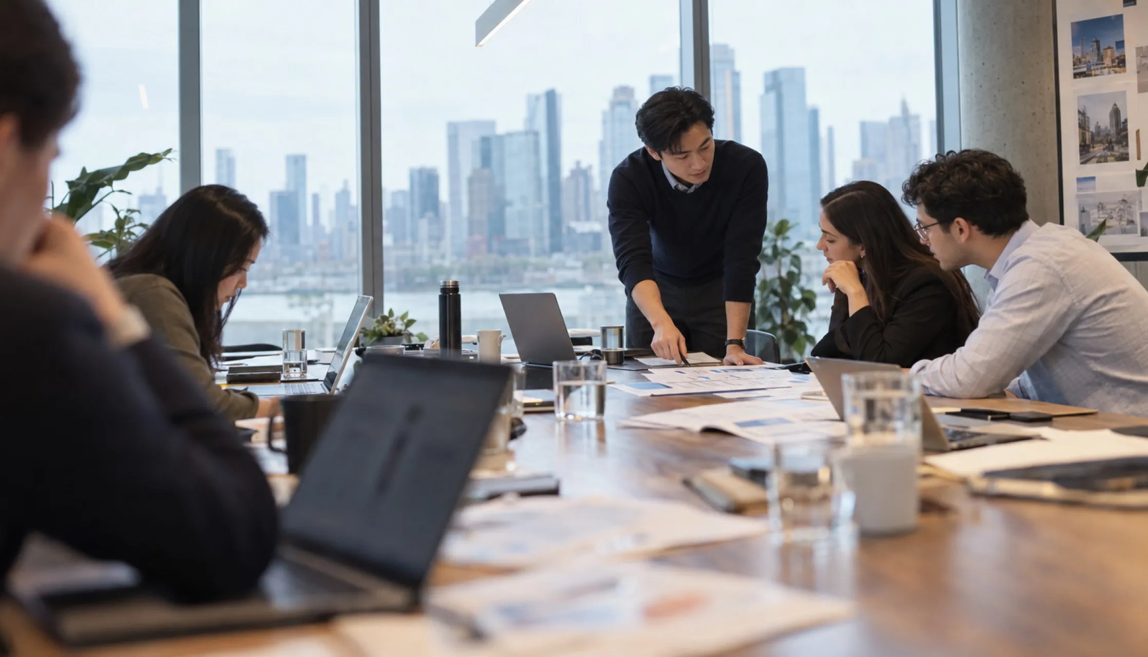 A financial analyst simulation: colleagues reviewing work together in an office.